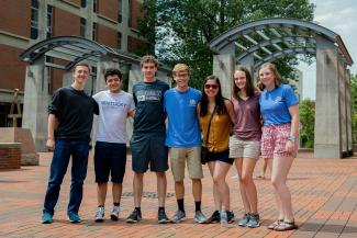 Group of freshman students standing near the arches in the Engineering courtyard.